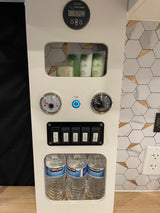 RV rental control panel: 97.4% battery, water gauges, pump, fresh/grey water switches, toiletries, and bottled water.