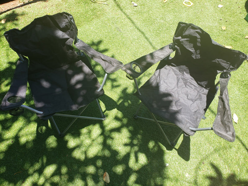 Two black folding chairs on artificial grass, dappled in tree shadows. Great for an RV rental outdoor setup. — photo 14