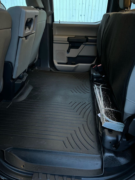 Spacious back seats with full-coverage rubber floor mat and sunshade for your next rv rental adventure. Clean vehicle interior.