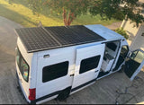 This custom white camper van with solar panels is perfect for your next RV rental adventure, offering off-grid mobile living.