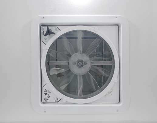 White ceiling fan in an RV rental, providing essential ventilation for a comfortable journey.