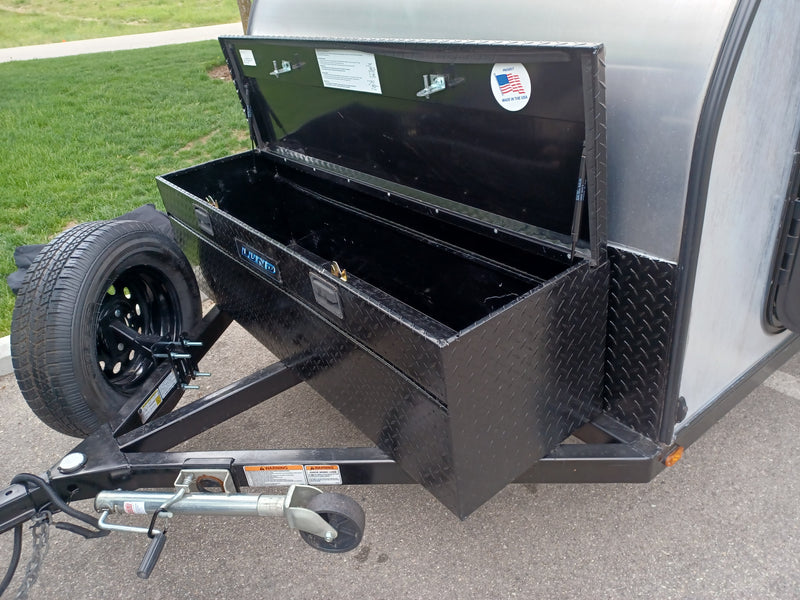 RV rental utility: Black diamond plate toolbox with open lid and spare tire on trailer tongue. — photo 12