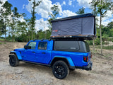 Blue Jeep Gladiator with a Roofnest tent and Smartcap. An exciting RV rental for your overlanding and camping adventures.
