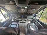 Spacious Mercedes-Benz RV rental cockpit with driver/passenger seats, dashboard, and sunshade.