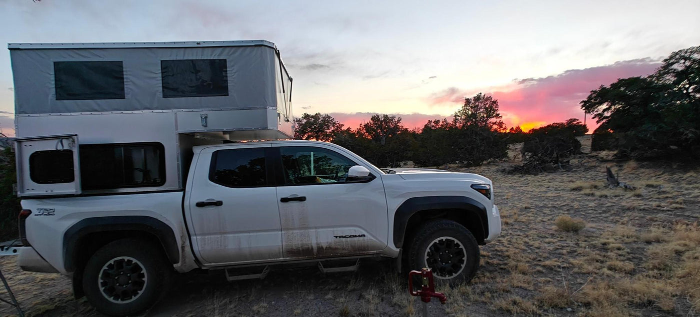 Camper set up at a high-desert camp at sunset, roof raised — photo 9