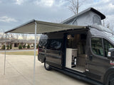 Explore this dark gray camper van with pop-top & extended awning. See the inviting interior of this rv rental.