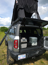 This RV rental Bronco features a rooftop tent, portable fridge, & toilet for overlanding adventures.
