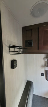 RV rental interior featuring a sleek counter, speaker, Furrion control panel, and comfy dinette seating.