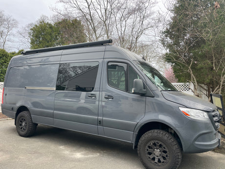 This gray Mercedes-Benz Sprinter van, an off-road camper for rv rental, is ready for your next adventure!