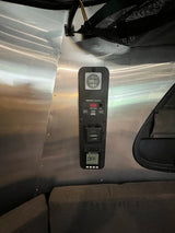 Essential RV rental control panel: SeeLevel tank monitor, Dometic system, and Suburban heater status (OFF) on metallic wall. Ready for camping.