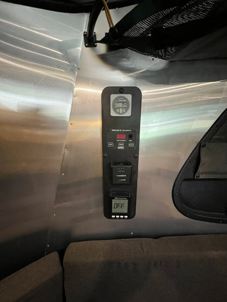 Essential RV rental control panel: SeeLevel tank monitor, Dometic system, and Suburban heater status (OFF) on metallic wall. Ready for camping.