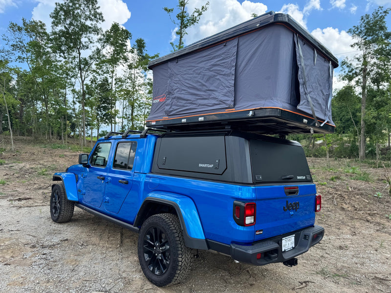  an overland adventure-ready **rv rental** alternative for camping.|This blue Jeep Gladiator pickup — photo 2