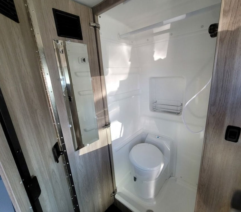  showcasing a Winnebago Solis's kitchen and innovative tech display for comfortable travels.|RV rental interior featuring a table with chips