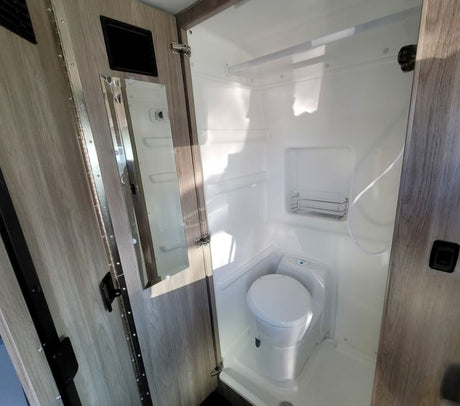  showcasing a Winnebago Solis's kitchen and innovative tech display for comfortable travels.|RV rental interior featuring a table with chips