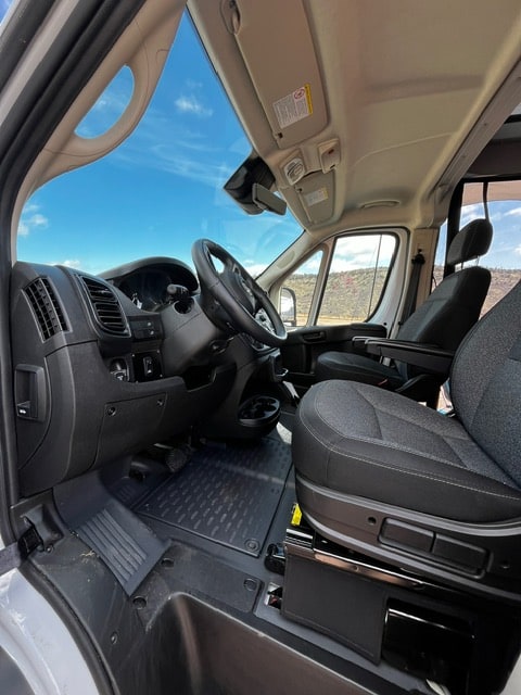  and chairs at a scenic campsite setup.|Scenic RV rental setup: White camper van with awning — photo 17
