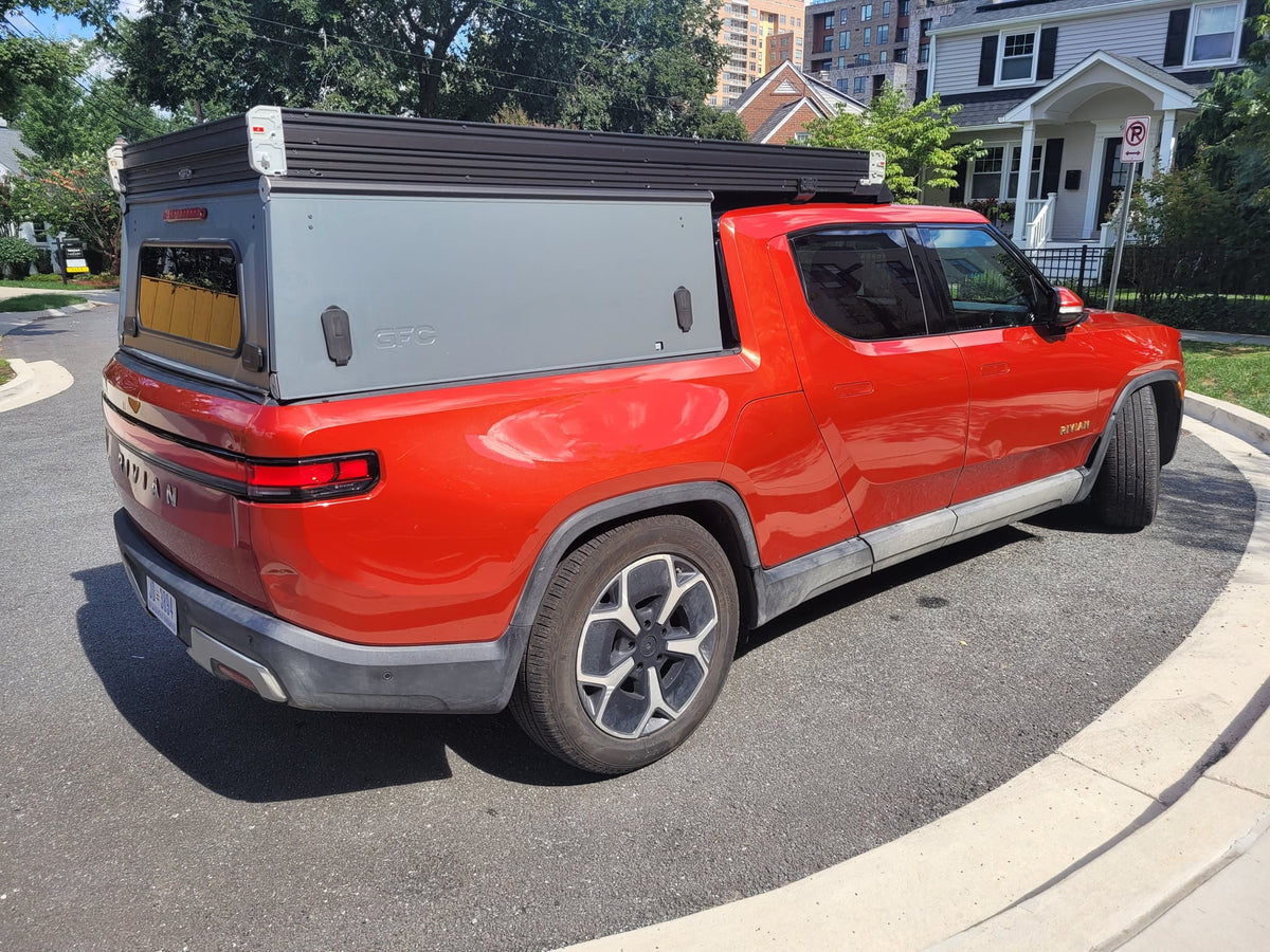  offering a unique RV rental option.|A red Rivian R1T electric truck — photo 8