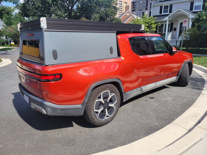  offering a unique RV rental option.|A red Rivian R1T electric truck — photo 8