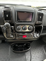 RV rental control panel: detailed view of vehicle interior with dashboard, Pioneer screen, climate controls, shifter, and charging ports.