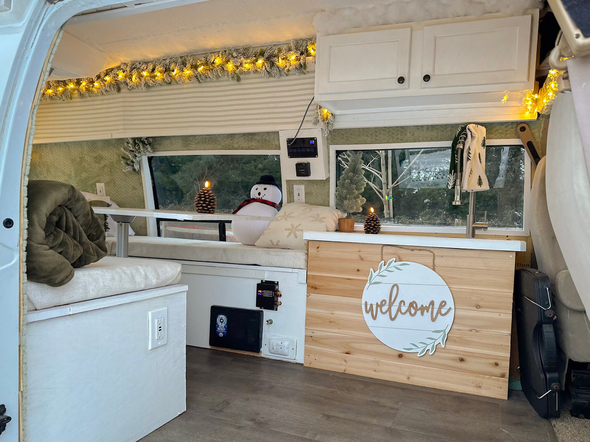 Cozy RV rental interior decorated for winter. Features a festive garland