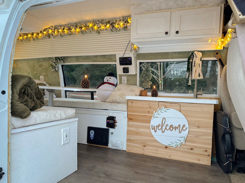 Cozy RV rental interior decorated for winter. Features a festive garland — photo 1