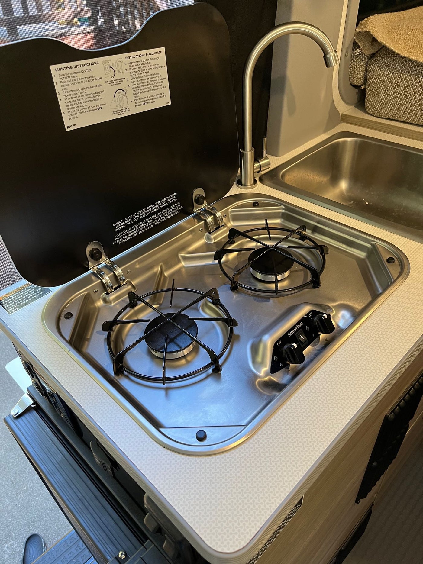  featuring rooftop solar panels and an AC unit.|rv rental: Camper van interior with raised bed — photo 12