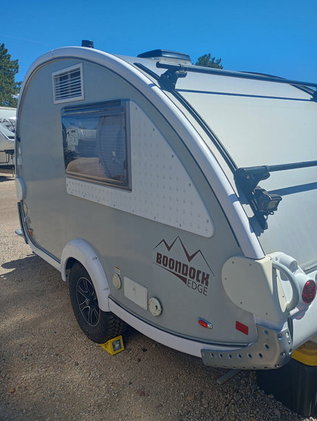 This light-colored Boondock Edge teardrop RV rental, perfect for outdoor adventures, is ready for your trip.