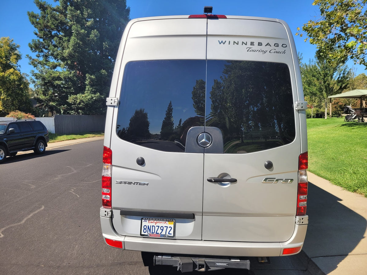  showing its rear with California license plate.|Silver Winnebago Sprinter touring coach — photo 6