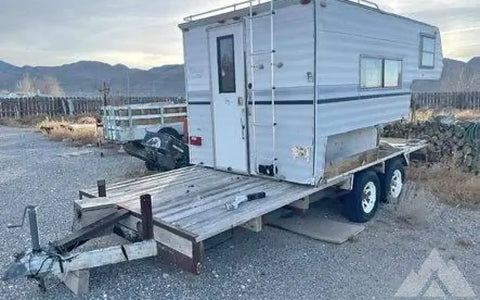 Cab over camper on flat bed trailer