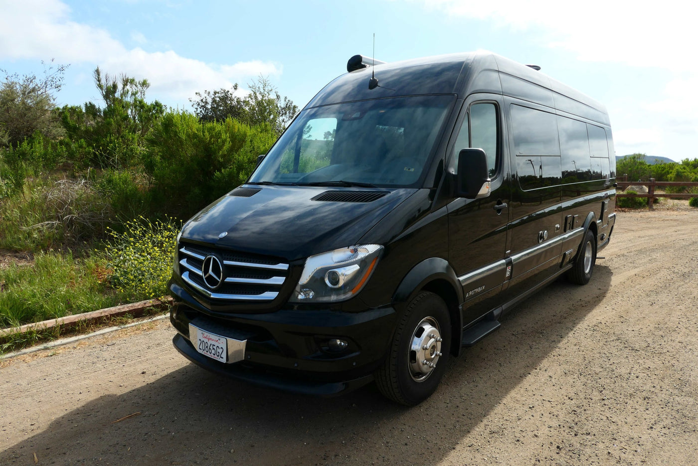  and a top-mounted AC unit.|This RV rental features a practical kitchen with a two-burner stove and a pot — photo 7