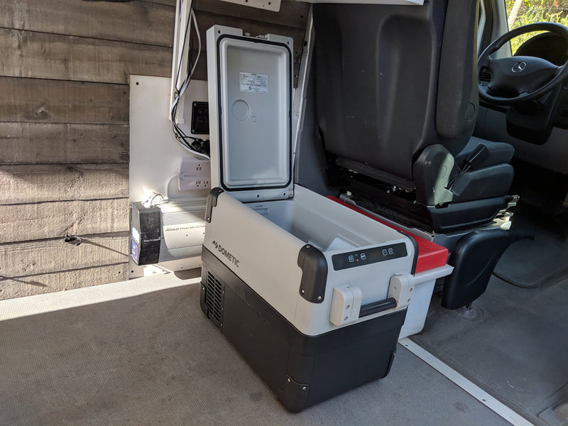 RV rental camper van interior featuring an open Dometic fridge, Absol inverter, and power outlets. — photo 19