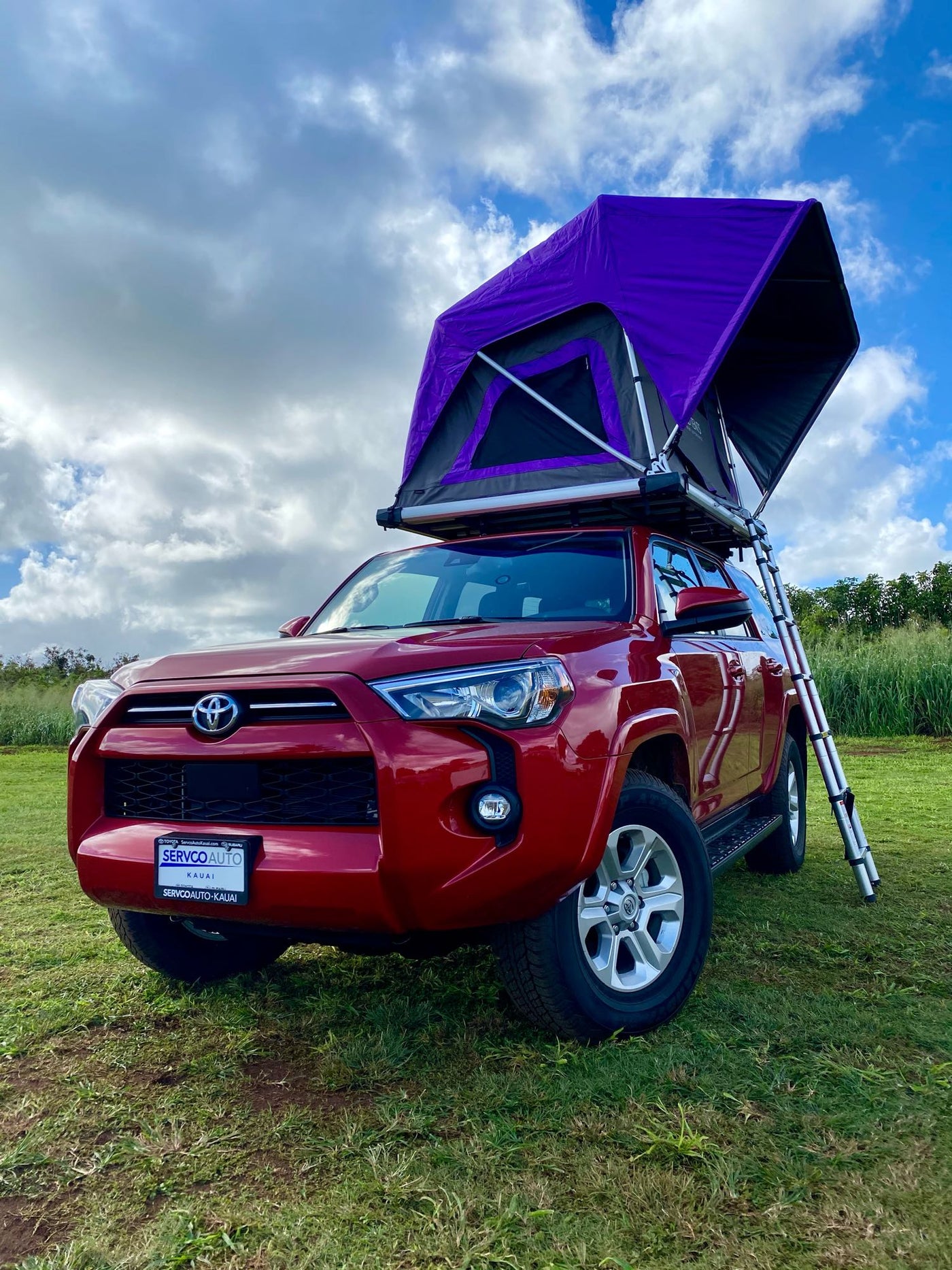 A red Toyota 4Runner SUV with a vibrant purple rooftop tent deployed, perfect for an RV rental outdoor adventure. — photo 5