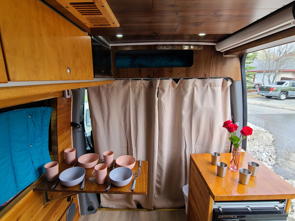 Wood-paneled RV rental with a fold-out dining table