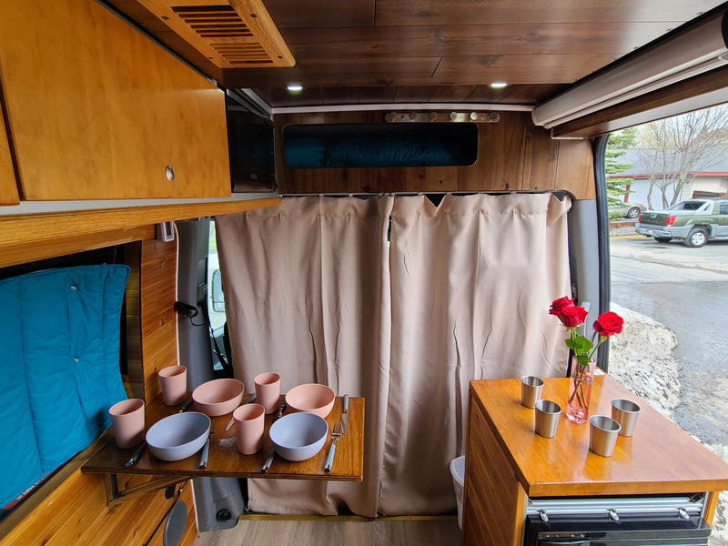 Wood-paneled RV rental with a fold-out dining table — photo 1