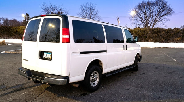 White passenger van in a parking lot
