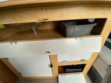 Light wood RV rental interior showing a functional sink area with a removable basin and multiple storage cabinets.