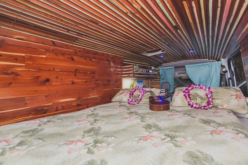  ready for your next rv rental.|Step into this unique RV rental: a cozy bed with ukulele & leis — photo 2