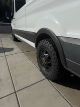 White Ford Transit **rv rental** van with rugged BFGoodrich off-road tires and fender flares.