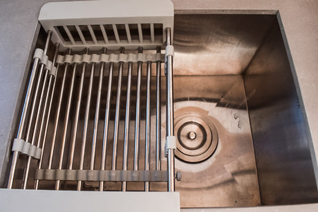 RV rental: Stainless steel kitchen sink with a convenient adjustable dish drying rack.