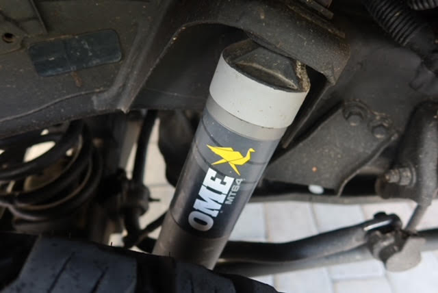 Underside detail of an Old Man Emu BP-51 rear shock mounted in the Tundra's rear suspension — photo 16