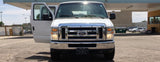 Clean white Ford van with open driver's door, available for rv rental and your next road trip adventure.