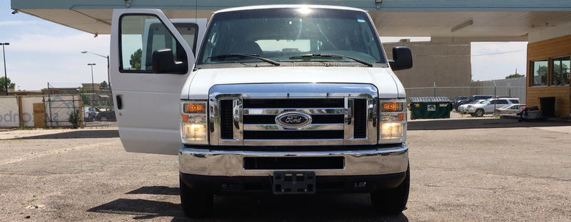 Clean white Ford van with open driver's door — photo 1