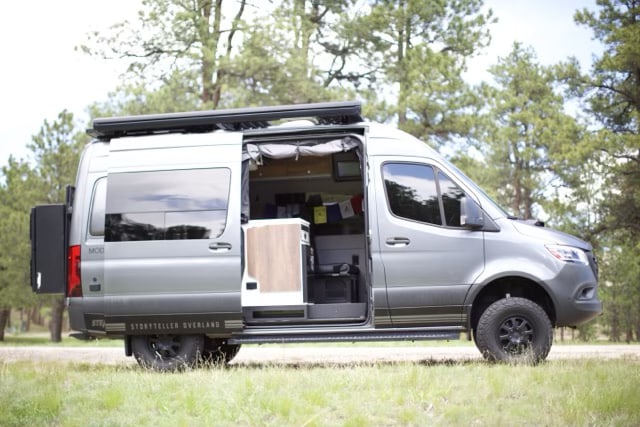  by a forest pond.|This grey Storyteller Overland camper van — photo 2