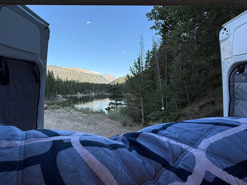 Cozy RV rental bed with serene lake & mountain view. Perfect for peaceful van life camping adventures. — photo 2