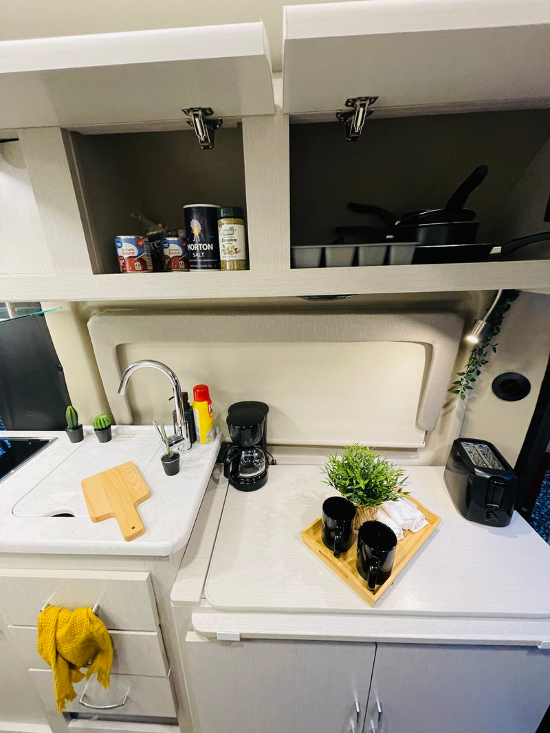  and the van's inviting interior.|Comfortable RV rental interior with a modern design — photo 7