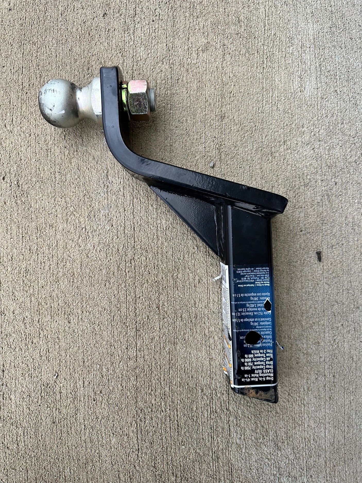 This black trailer hitch ball mount with a silver ball is ready for towing. Check capacities for your RV rental.