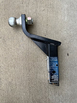 This black trailer hitch ball mount with a silver ball is ready for towing. Check capacities for your RV rental.