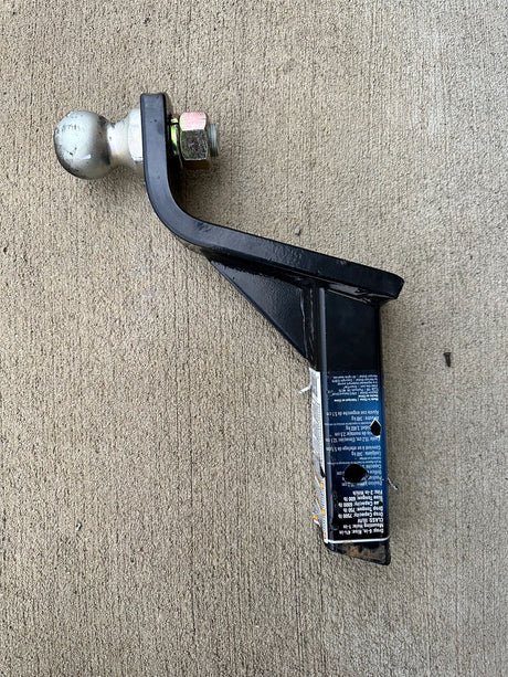This black trailer hitch ball mount with a silver ball is ready for towing. Check capacities for your RV rental.