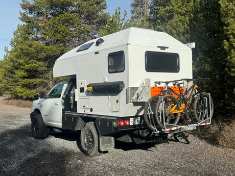 Explore the outdoors with this overland truck camper RV rental, complete with mountain bikes for adventure travel & camping.