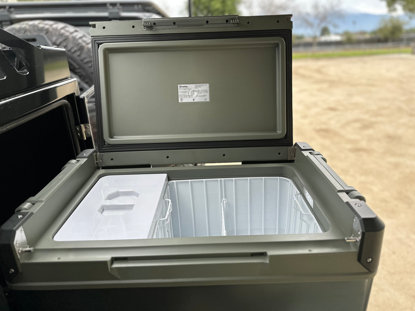 An open Truma portable cooler, ideal for an rv rental trip. This travel fridge keeps provisions fresh on the go.