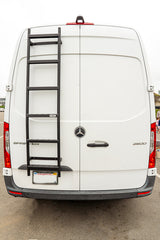 Rear view of a white Mercedes-Benz Sprinter van with a ladder, ideal for RV rental adventures.